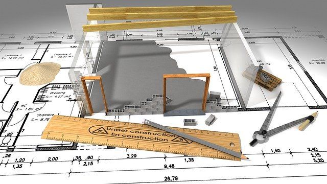 Maqueta de una vivienda sobre los planos acotados, con escalímetro y compás